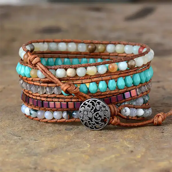 Bracelet Boho (Wrap) Coquillage Cauris posé sur un sol en pierre vue de derrière kaosix