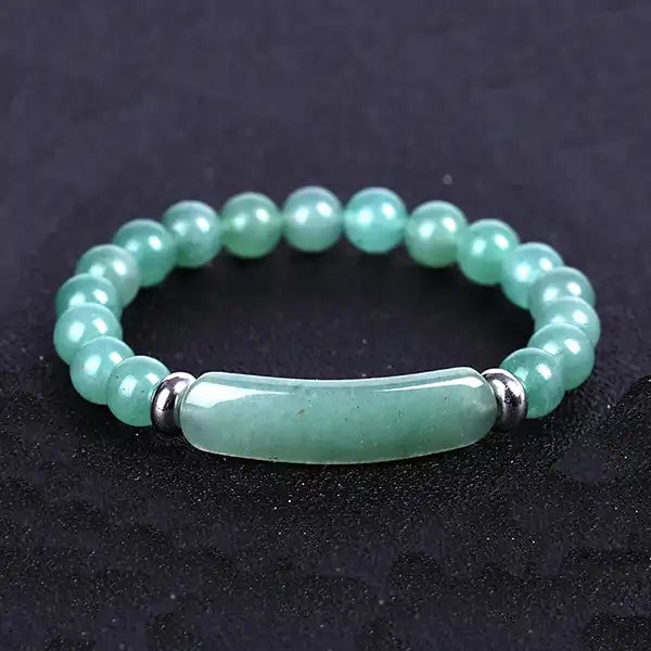 Bracelet en Aventurine Bande Courbe et Perles sur un sol noir kaosix