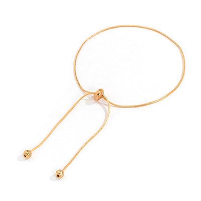 Chaine de cheville fine Lacets et Boules plaqué or sur fond blanc Kaosix