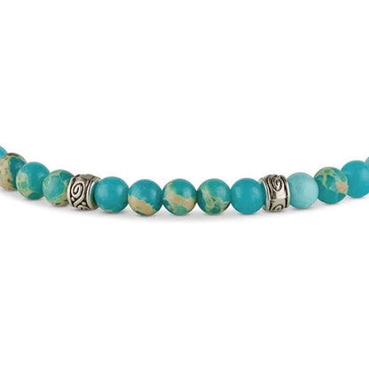 Bracelet Tibétain Bleu Turquoise sur sol blanc vue en gros plan des perles kaosix