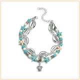 Bracelet de cheville en coquillages cauris étoiles de mer avec amulette tortue de mer sur fond blanc Kaosix