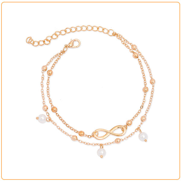 Bracelet de cheville infini et perles chainette dorée sur fond blanc Kaosix