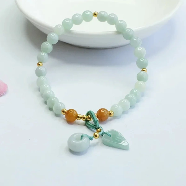 Bracelet en quartz fraise et quartz vert posé sur une assiette Kaosix