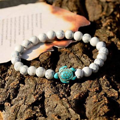 Bracelet howlite blanche Tortue Marine sur un rocher gris au soleil Kaosix