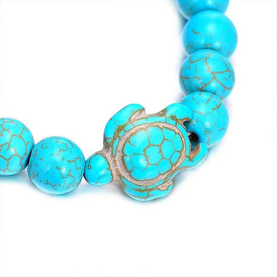 Bracelet pierre bleu turquoise avec gros plan sur la tortue marine sur fond blanc Kaosix