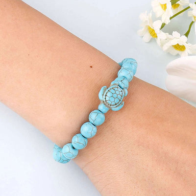 Bracelet pierre bleu turquoise tortue marine  au poignet d'une jeune fille Kaosix