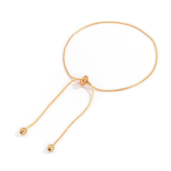 Chaine de cheville fine Lacets et Boules plaqué or sur fond blanc Kaosix