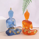 Deux Statuette de Bouddha en résine translucide orange et bleu l'une de face et l'autre de dos Kaosix
