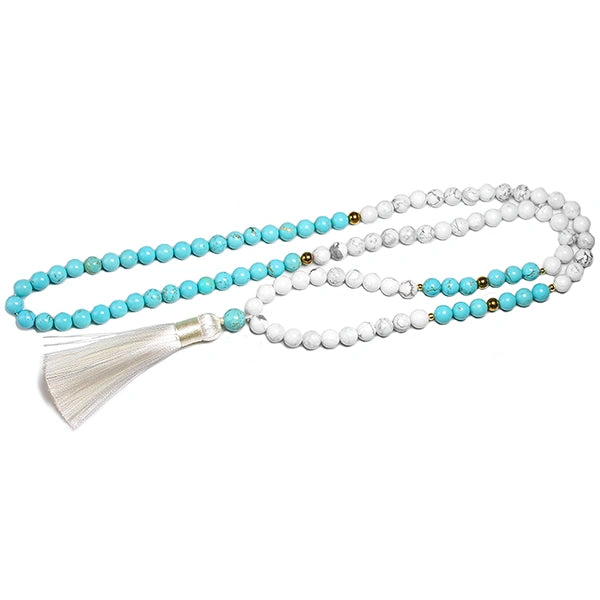 Mala 108 perles howlite blanche et turquoise pompon déroulé sur fond blanc Kaosix