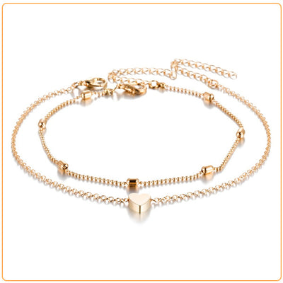 Set de deux bracelets de cheville avec amulette cœur couleur doré sur fond blanc Kaosix