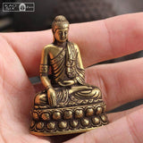 Statue Bouddha de la médecine posé sur une main d'homme kaosix