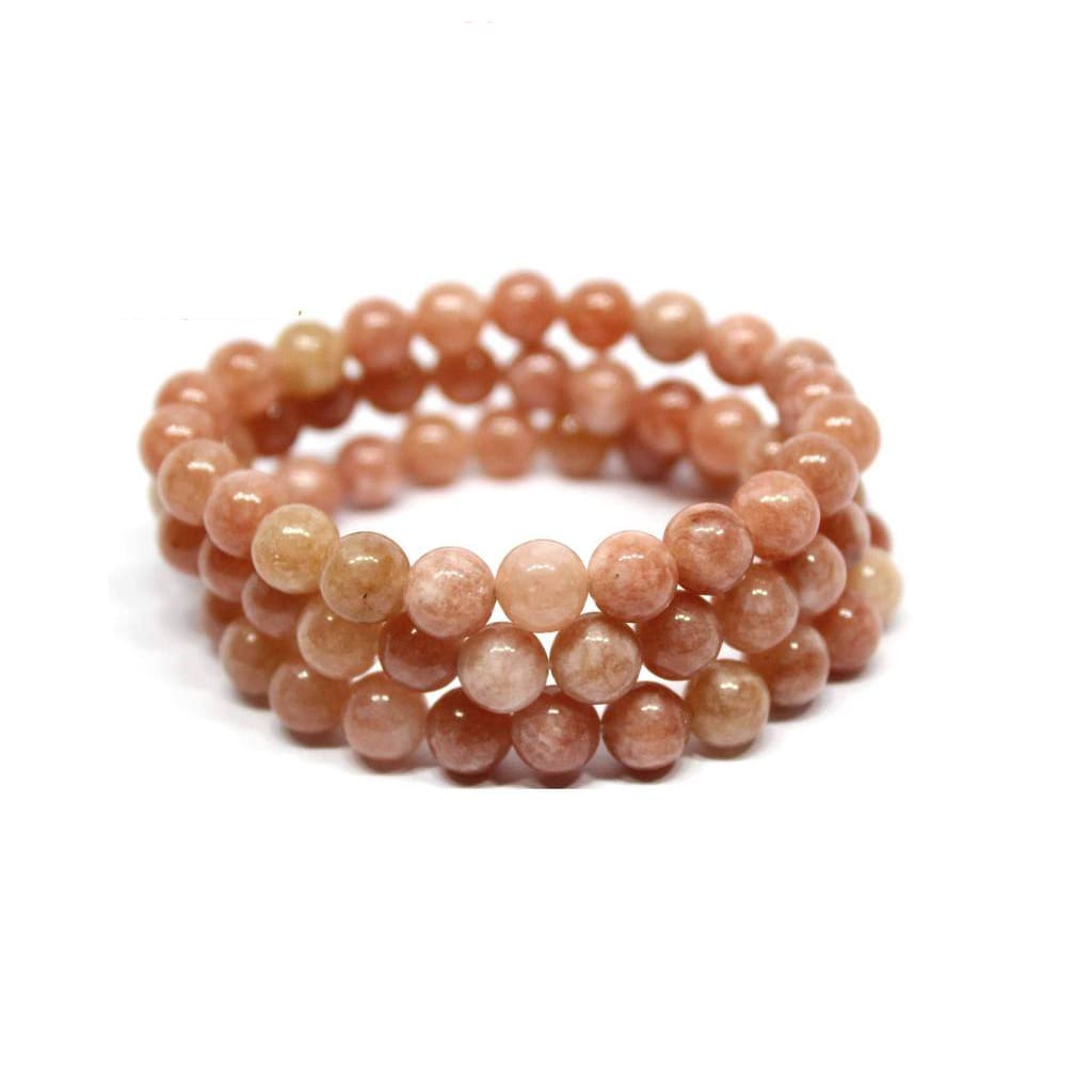 3 bracelet en pierre de soleil énergie posés les uns sur les autres sur fond blanc Kaosix