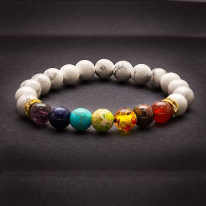 Bracelet 7 chakras calme Howlite posé sur tapis gris Kaosix