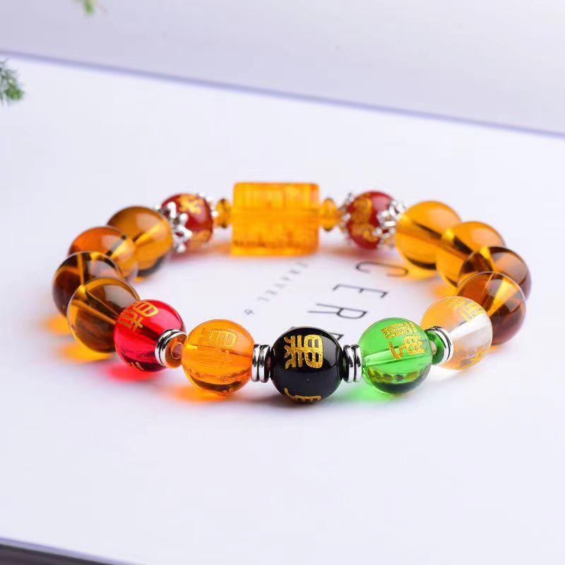 Bracelet Feng Shui Citrine Cinq Dieux et Cinq Éléments sur une feuille de papier blanc Kaosix