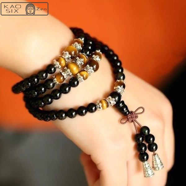 bracelet mala 108 perles onyx noir œil de tigre enroulé sur un poignet de femme