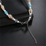 Bracelet de cheville en coquillages avec amulette étoile de mer et gros plan sur le fermoir mousqueton Kaosix