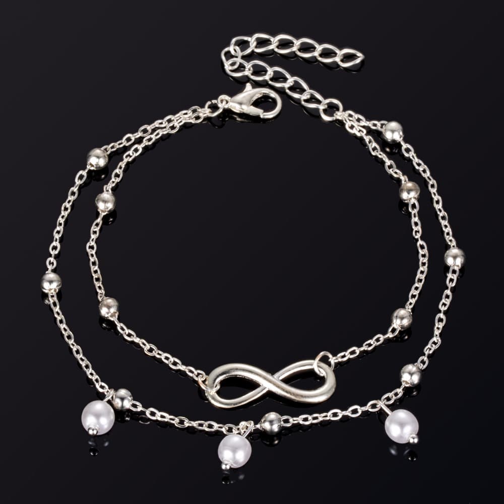 Bracelet de cheville infini et perles chainette argentée sur fond noir Kaosix