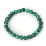 Bracelet en malachite transformation boule 8 mm sur fond blanc avec cadre orange Kaosix