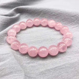 Bracelet en quartz rose amour boule 8 mm sur une étoffe grise Kaosix