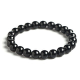Bracelet en tourmaline noire ancrage boule 8 mm sur fond blanc avec cadre orange Kaosix