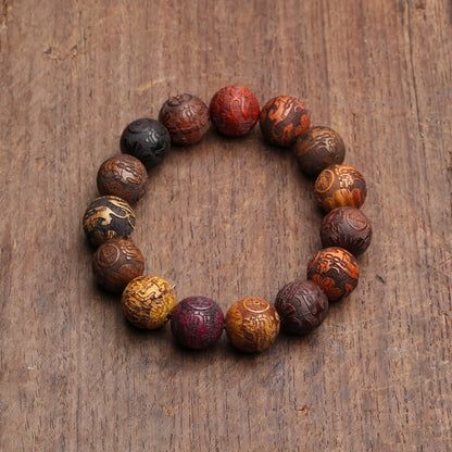 Bracelet feng shui Pi Xiu en perles de bois colorées sur une planche en bois Kaosix