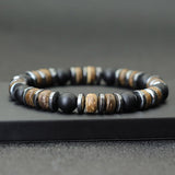 Bracelet homme onyx noir hématite bois de cocotier sur un socle noir Kaosix