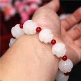 Bracelet jade blanc lotus au poignet d'une femme Kaosix