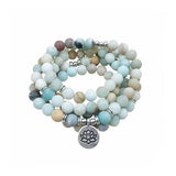 Bracelet mala 108 perles amazonite lotus sur fond blanc avec cadre orange Kaosix