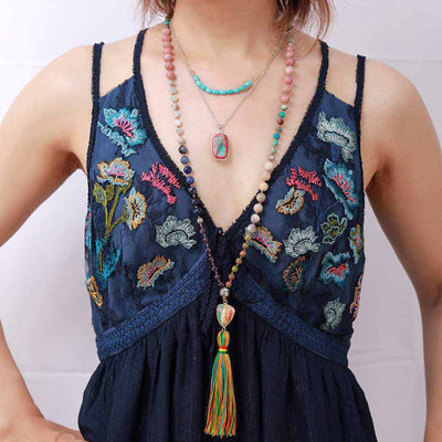 Bracelet mala 108 perles jaspe turquoise améthyste rhodonite posé autour du cou d'une femme Kaosix