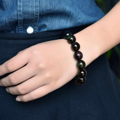 Bracelet obsidienne noire “stabilité” au poignet d'une jeune fille en gros plan Kaosix