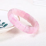 Bracelet pierres plates (plaquettes) quartz rose sur fond blanc Kaosix posé à moitié sur une assiette Kaosix