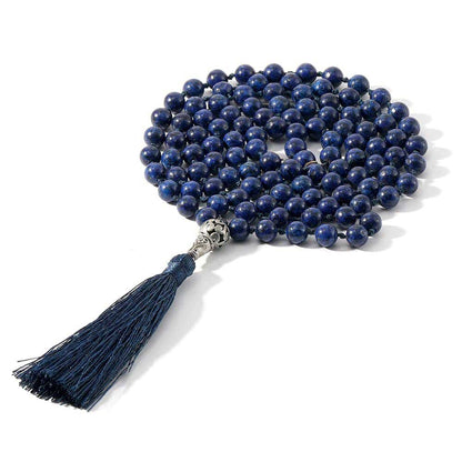 Mala 108 perles Lapis Lazuli et symbole arbre de vie enroulé sur un sol blanc Kaosix