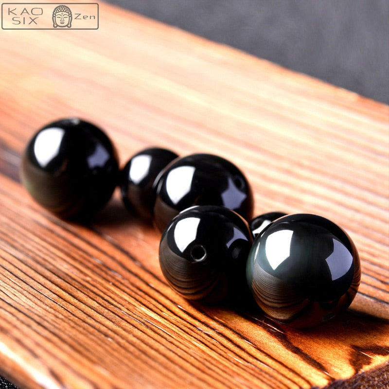 5 boules pierres obsidienne œil céleste sur planche en bois clair kaosix