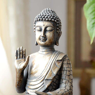 Petite statuette bouddha assis Thaïlande posture Abhaya mudra vue de près kaosix